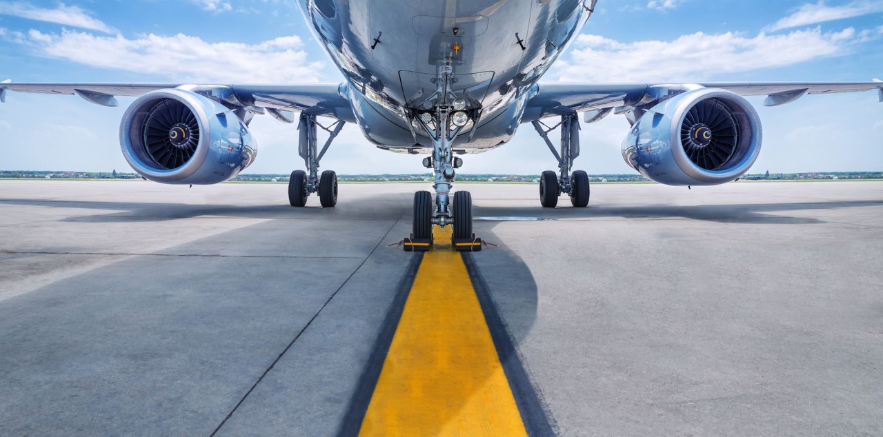 Aeroplane on runway with cloudy sky
